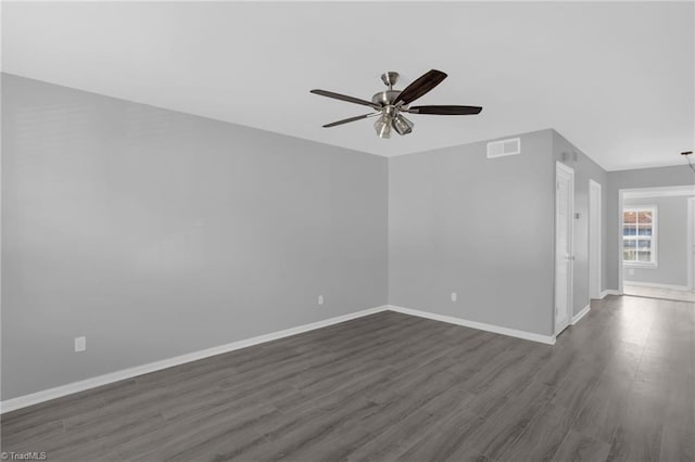 empty room featuring ceiling fan and dark hardwood / wood-style flooring