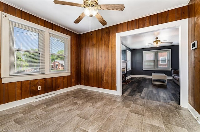 2110 E Green Dr, High Point, NC 27260 - spare room featuring a fireplace, wood walls, and baseboards