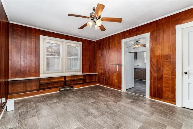 2110 E Green Dr, High Point, NC 27260 - spare room featuring crown molding, wood walls, and a ceiling fan
