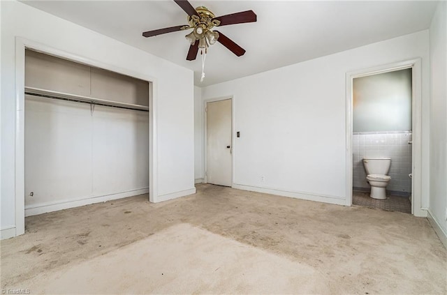 2110 E Green Dr, High Point, NC 27260 - unfurnished bedroom with carpet, a closet, ensuite bathroom, baseboards, and ceiling fan