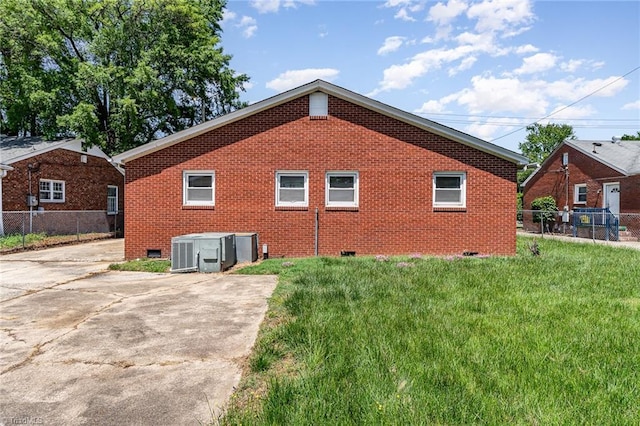 2110 E Green Dr, High Point, NC 27260 - view of home's exterior with fence, central AC, crawl space, brick siding, and a lawn