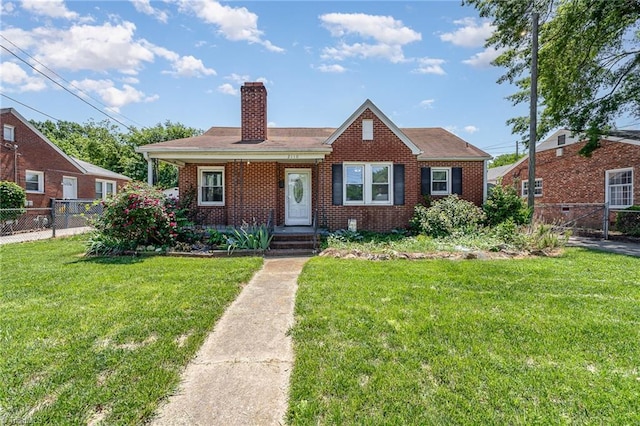2110 E Green Dr, High Point, NC 27260 - bungalow featuring a chimney, a front yard, brick siding, and fence