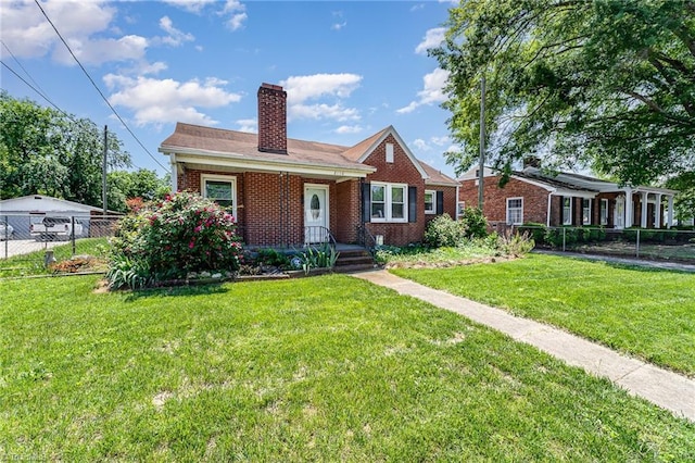 2110 E Green Dr, High Point, NC 27260 - bungalow with a chimney, a front yard, brick siding, and fence