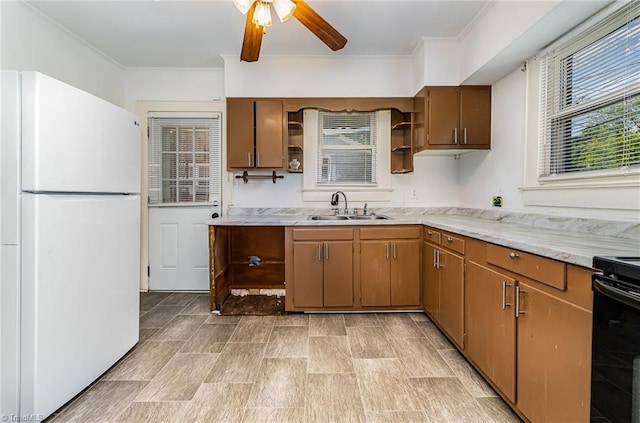 2110 E Green Dr, High Point, NC 27260 - kitchen with a sink, freestanding refrigerator, ornamental molding, open shelves, and ceiling fan