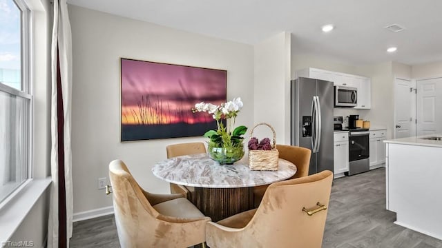 dining space with recessed lighting, baseboards, visible vents, and wood finished floors