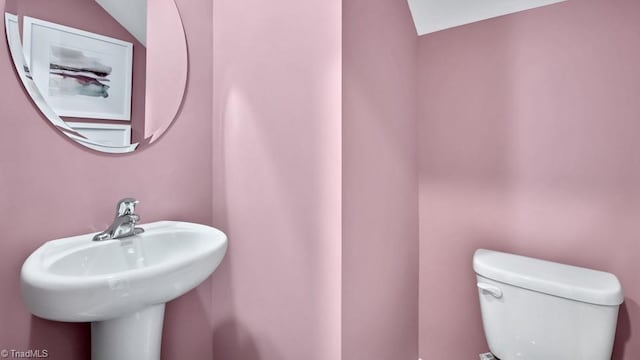 bathroom featuring toilet and a sink