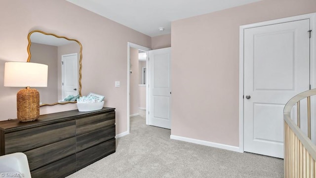 bedroom featuring baseboards and light colored carpet