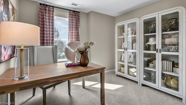 carpeted office space with baseboards and visible vents