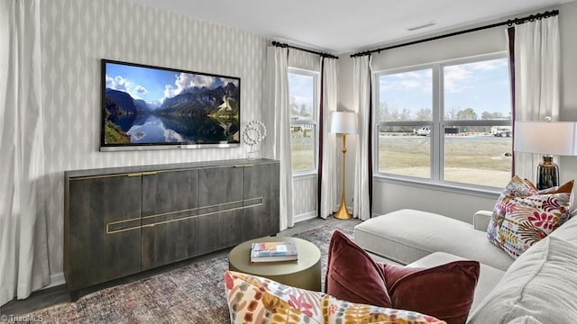 living room with wallpapered walls and visible vents
