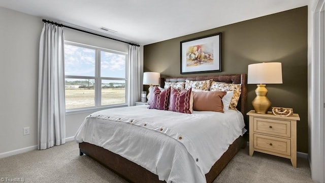 bedroom featuring baseboards, visible vents, and carpet