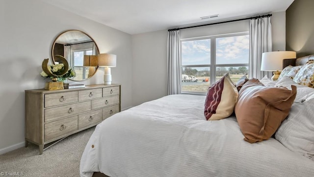 bedroom featuring light carpet, baseboards, and visible vents