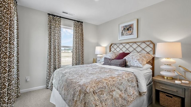 bedroom with baseboards, carpet flooring, and visible vents