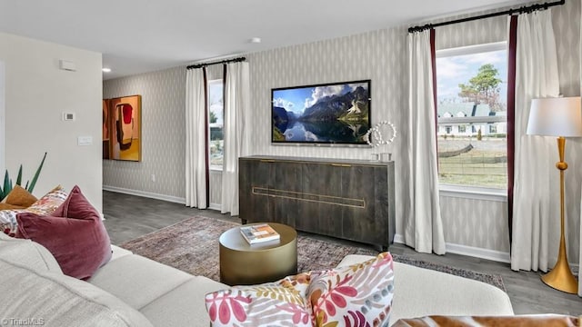 living room with a wealth of natural light, wallpapered walls, and baseboards