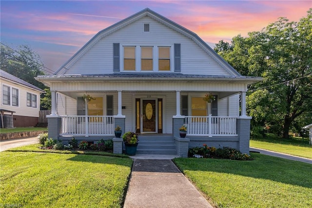 view of front of house featuring a yard and a porch