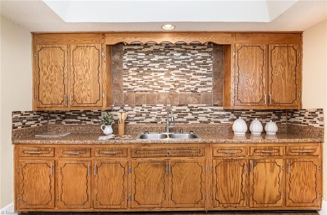 kitchen featuring a skylight, sink, and decorative backsplash