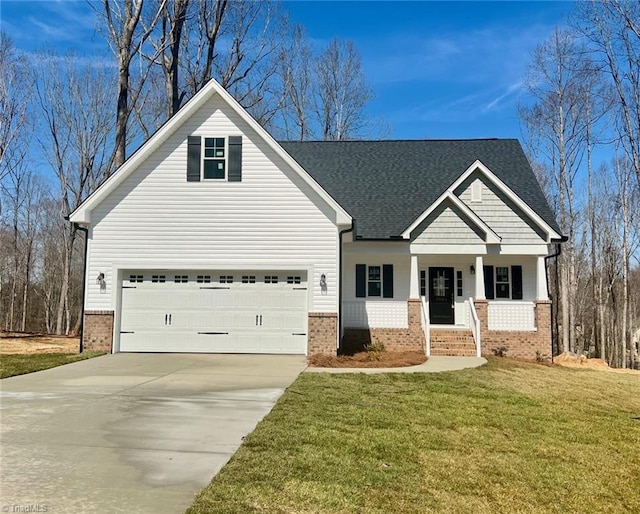 view of front of home with a porch, driveway, brick siding, and a front yard