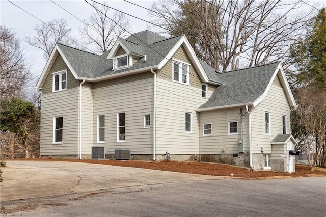 view of side of property with central AC unit