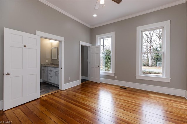 unfurnished bedroom with sink, light hardwood / wood-style flooring, ceiling fan, connected bathroom, and ornamental molding