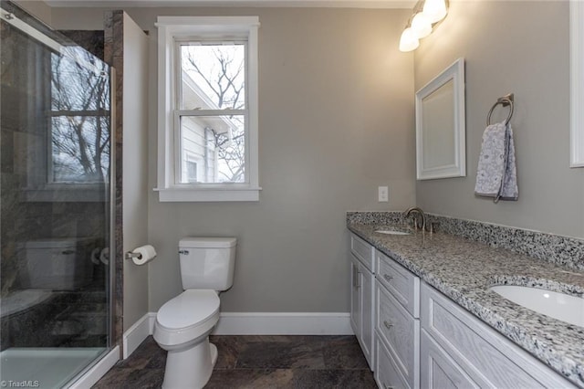 bathroom with walk in shower, vanity, and toilet