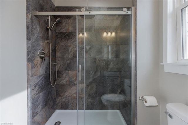 bathroom with walk in shower and toilet