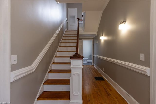 stairs with hardwood / wood-style floors