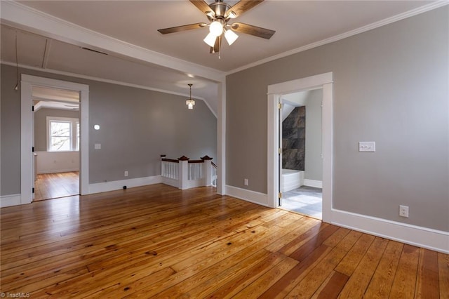 spare room with wood-type flooring, ornamental molding, and ceiling fan