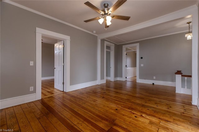 empty room featuring crown molding, hardwood / wood-style flooring, and ceiling fan