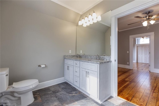 bathroom featuring vanity, wood-type flooring, ornamental molding, and toilet