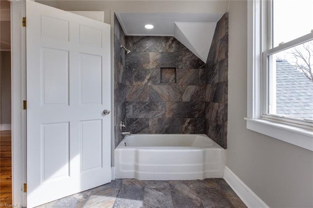 bathroom featuring tiled shower / bath and a wealth of natural light