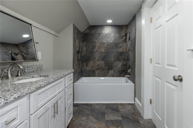 bathroom featuring vanity and tiled shower / bath combo