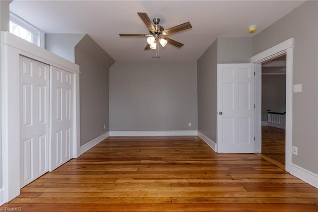 unfurnished bedroom featuring light hardwood / wood-style flooring, a closet, and ceiling fan