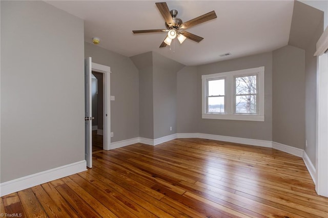 spare room featuring vaulted ceiling, ceiling fan, and light hardwood / wood-style flooring