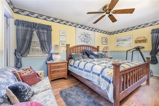 bedroom with ceiling fan and wood-type flooring