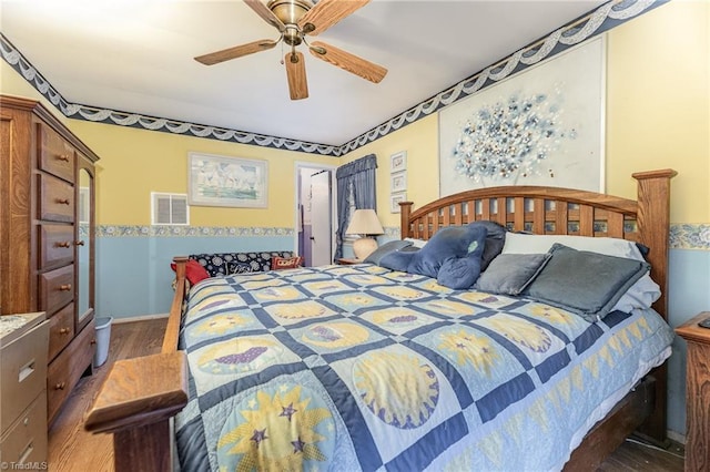 bedroom with ceiling fan and dark hardwood / wood-style floors