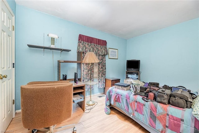 bedroom with hardwood / wood-style floors