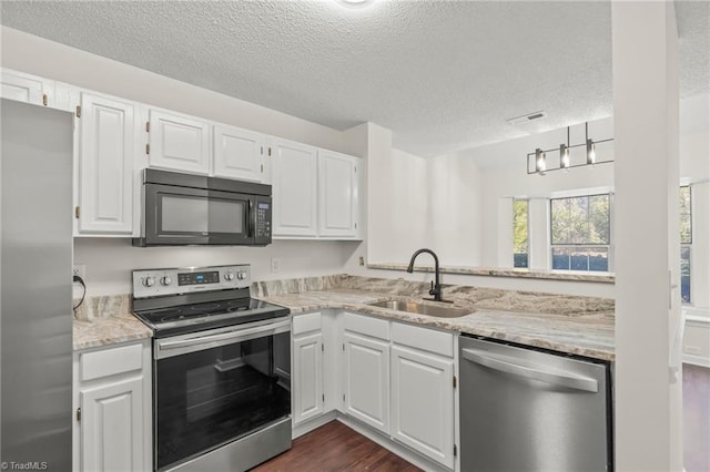 kitchen with stainless steel appliances, white cabinetry, and sink