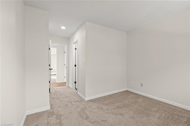 empty room featuring light colored carpet