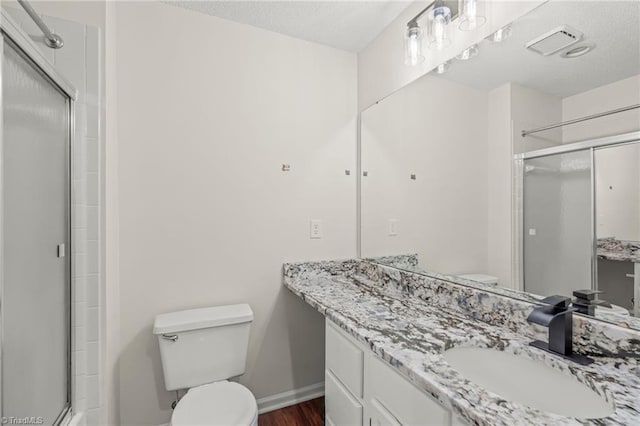 bathroom with toilet, wood-type flooring, walk in shower, and vanity