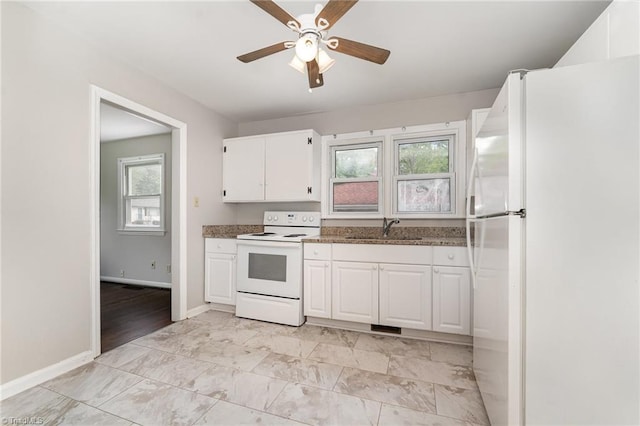 1705 Boyden St, Greensboro, NC 27403 - kitchen with white appliances, a sink, white cabinets, ceiling fan, and baseboards