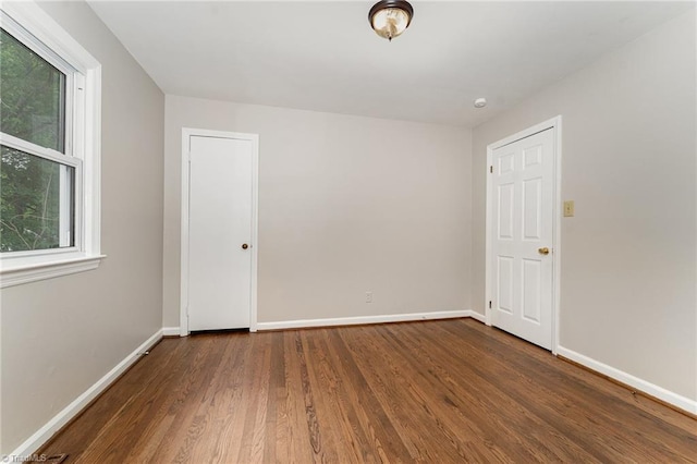 1705 Boyden St, Greensboro, NC 27403 - spare room featuring wood finished floors and baseboards
