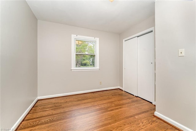 1705 Boyden St, Greensboro, NC 27403 - unfurnished bedroom featuring light wood-style floors, baseboards, and a closet