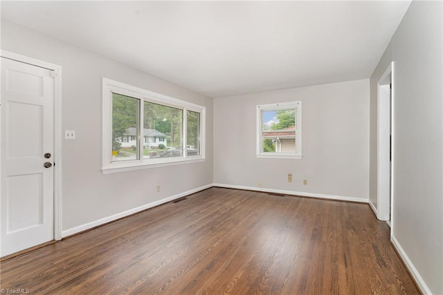 1705 Boyden St, Greensboro, NC 27403 - spare room with dark wood-type flooring and baseboards