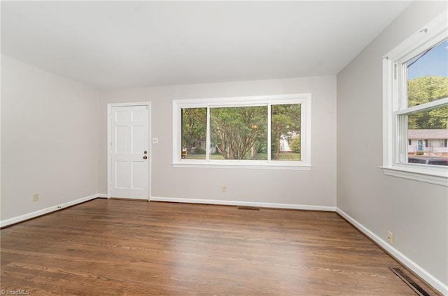 1705 Boyden St, Greensboro, NC 27403 - spare room featuring plenty of natural light, wood finished floors, and baseboards