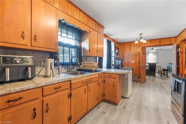 kitchen with a sink, a textured ceiling, a healthy amount of sunlight, and light countertops