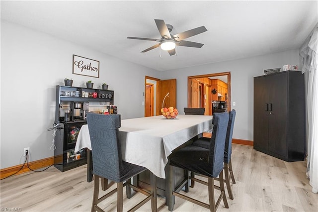 dining space featuring ceiling fan, baseboards, and light wood-type flooring