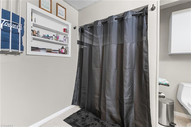 full bath featuring baseboards, tile patterned floors, and a shower with curtain