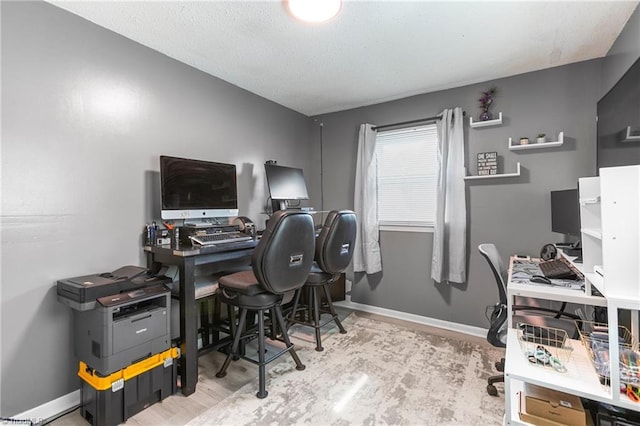 office space featuring baseboards and wood finished floors