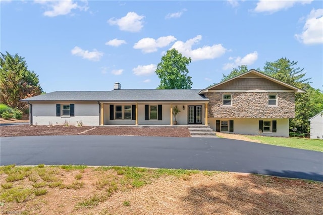 135 Boxwood Cir, Advance, NC 27006 - view of front of house with a porch, stone siding, and a chimney