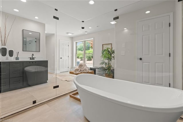 135 Boxwood Cir, Advance, NC 27006 - full bath featuring vanity, a freestanding tub, recessed lighting, and tile patterned floors