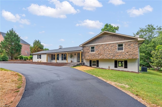 135 Boxwood Cir, Advance, NC 27006 - view of front of home featuring covered porch, stone siding, cooling unit, and a front lawn